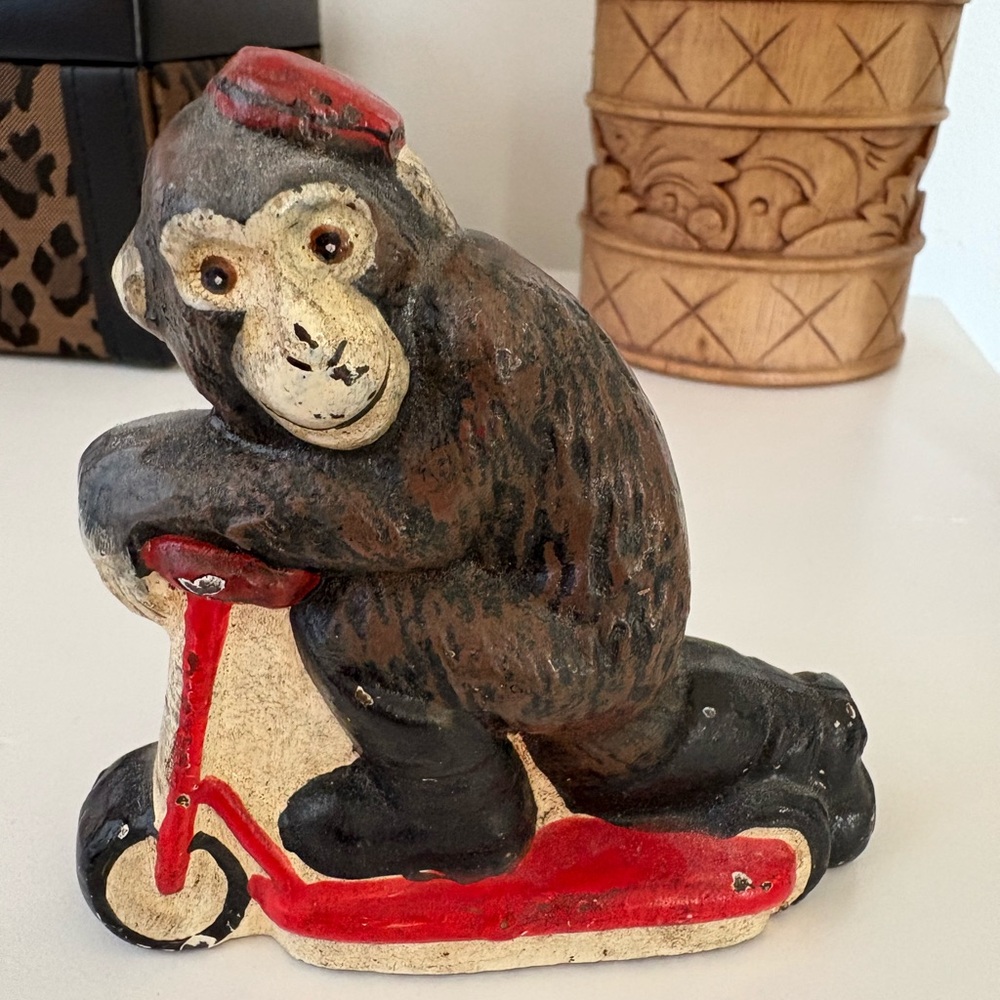 Vintage Cast Iron Monkey with Red Pill Box Hat on Scooter